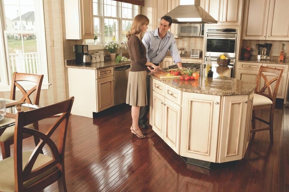 High gloss dark hardwood floors in a traditional kitchen and dining room 